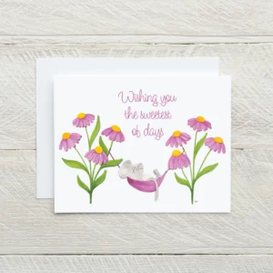 Paper sculpture greeting card showing a tiny mouse sleeping in a pink coneflower surrounded by blooms and a message at the top reading "Wishing you the sweetest of days"